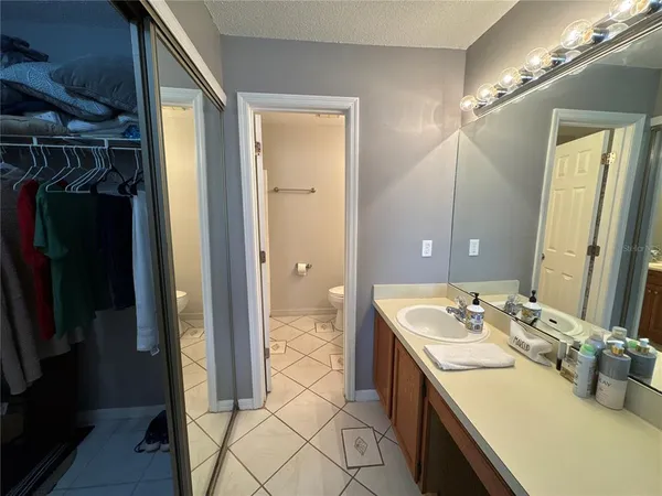 a bathroom with a sink toilet and mirror