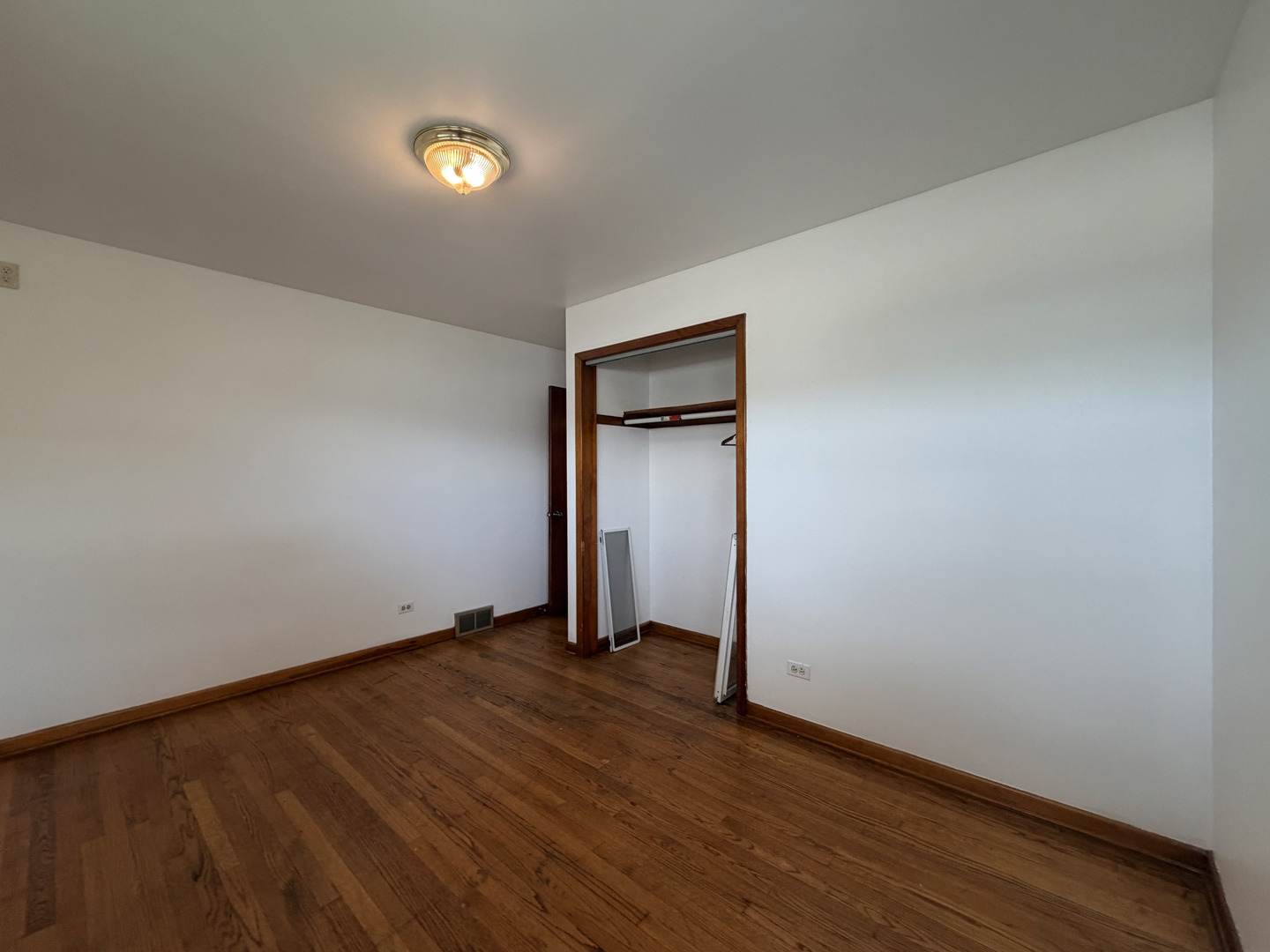 128 North York Road Bensenville, IL 60106 - Photo 17 of 39 a view of an empty room with wooden floor and closet