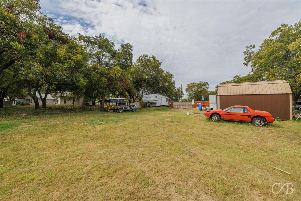 411 Hamby Road Clyde, TX 79510 - Photo 6 of 7 a view of yard with swimming pool and trees in the background