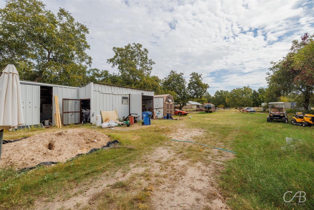 411 Hamby Road Clyde, TX 79510 - Photo 7 of 7 a view of a yard with car parked on the side of the road