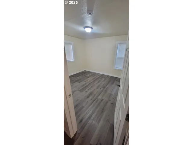 a view of a room with wooden floor