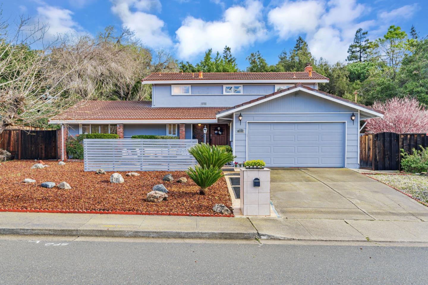 a front view of a house with garden