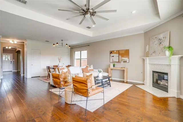 a living room with patio furniture and a fireplace