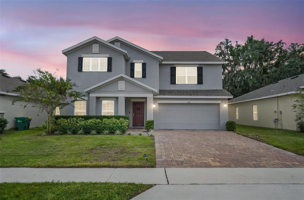 a front view of a house with a yard and garage