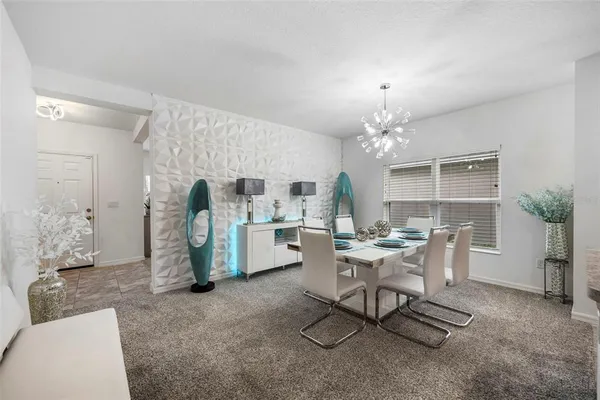 a kitchen with a dining table and chairs