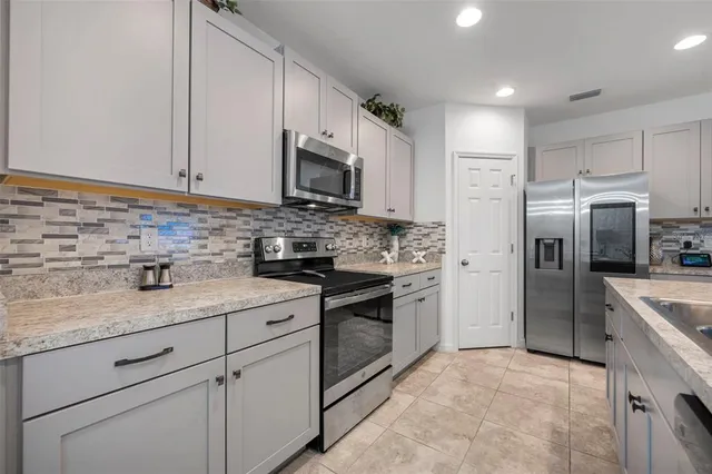 a living room with furniture flowerpot and a chandelier