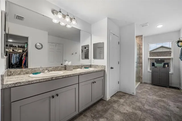 a bathroom with a granite countertop sink a toilet and a mirror