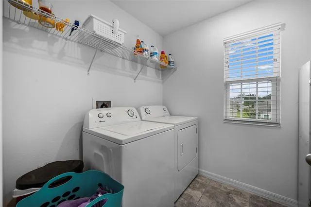 an aerial view of a house with a yard and a large pool