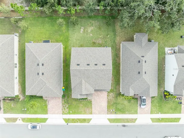 an aerial view of residential house with outdoor space and swimming pool