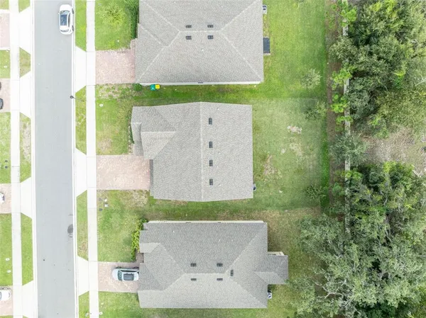 an aerial view of residential houses with outdoor space and swimming pool