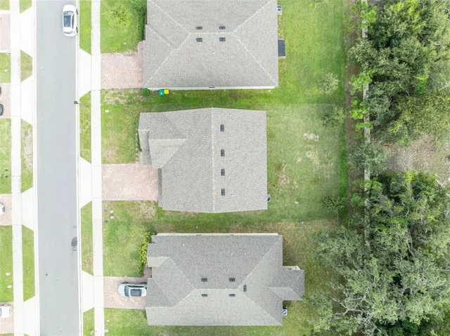 an aerial view of residential houses with outdoor space and swimming pool