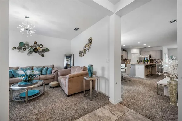 a living room with furniture potted plant and a window