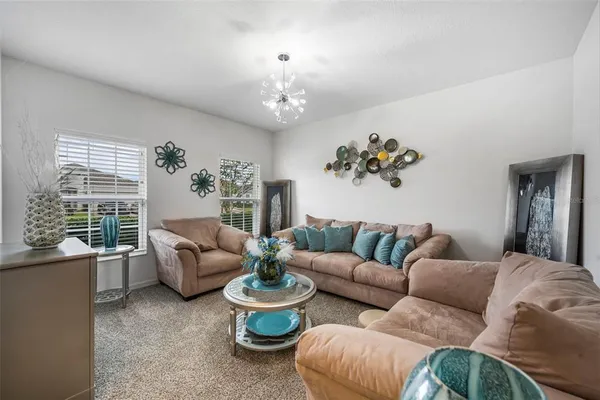 a living room with furniture and a chandelier
