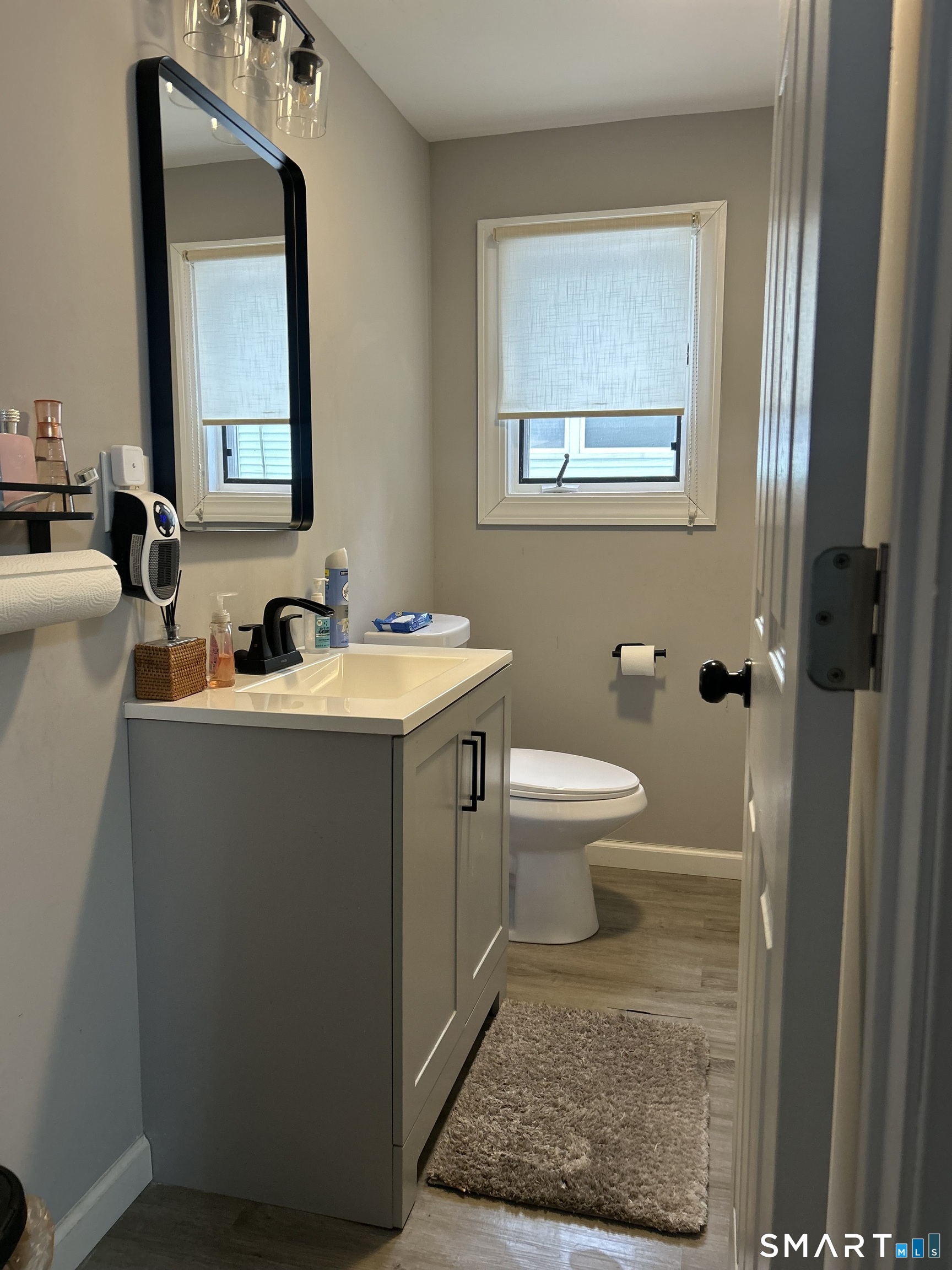 146 Liberty Street Middletown, CT 06457 - Photo 11 of 11 a bathroom with a toilet a sink and mirror
