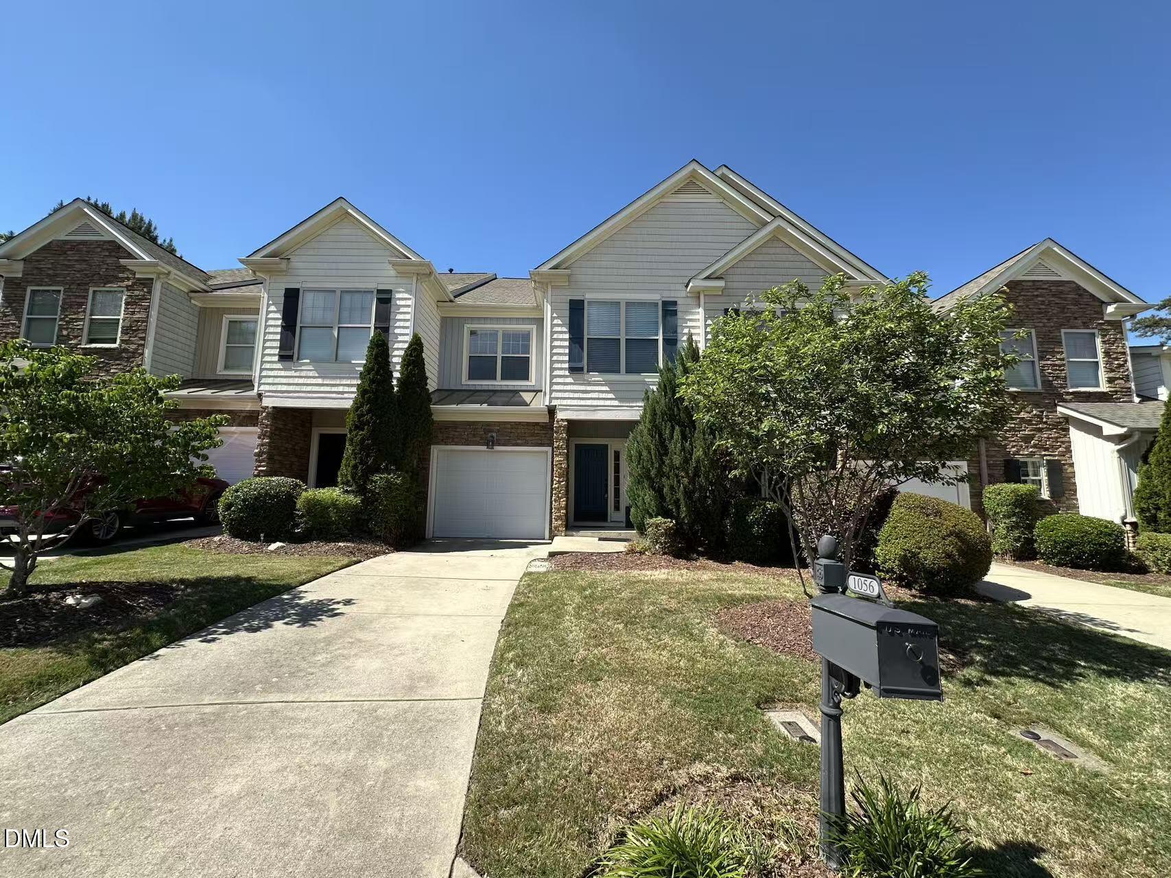 1056 Indigo Ridge Place Cary, NC 27519 - Photo 1 of 33 a front view of a house with a yard
