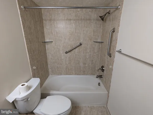 a bathroom with a toilet and a bathtub