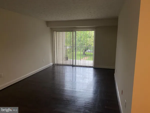 a view of wooden floor and a window in an empty room
