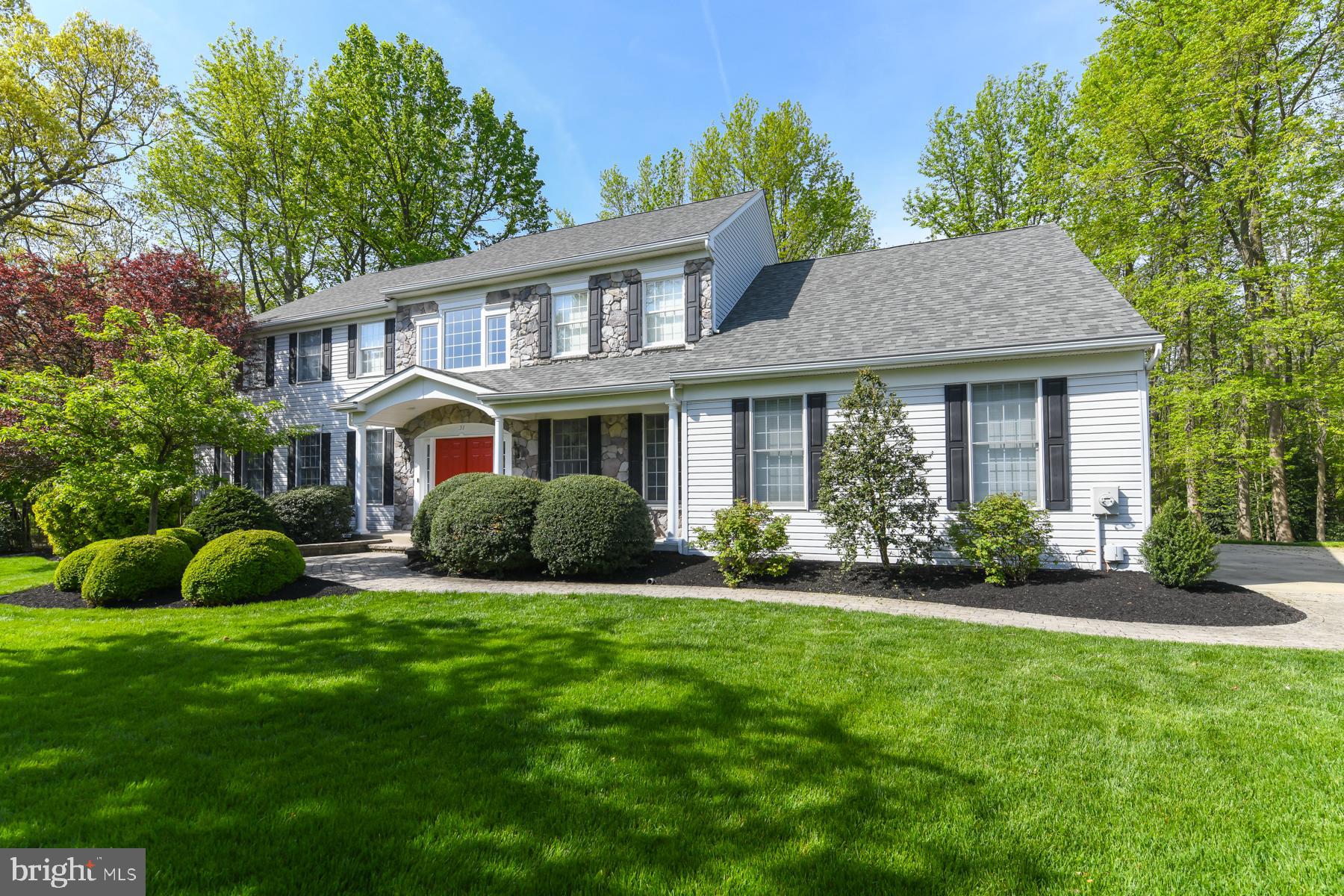 31 Millwood Drive Mickleton, NJ 08056 - Photo 2 of 62 a front view of a house with a garden and porch
