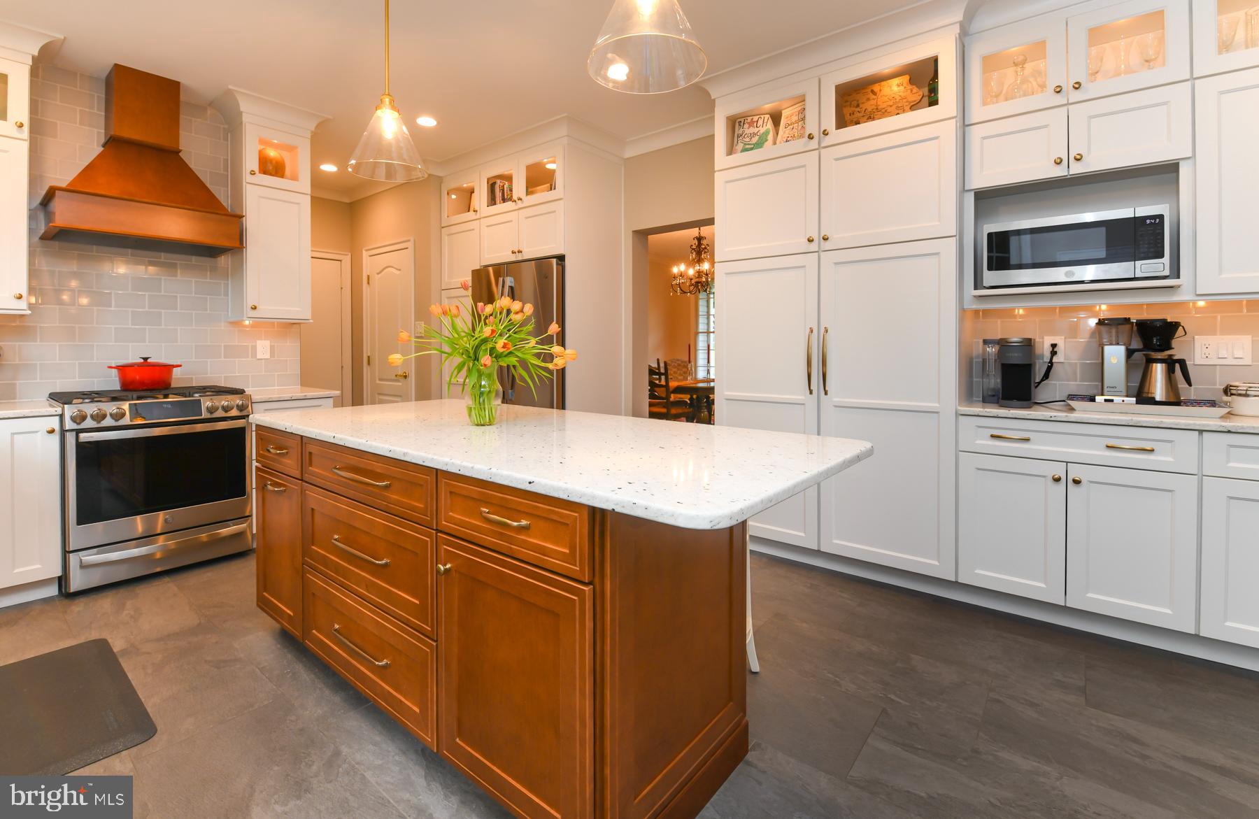 31 Millwood Drive Mickleton, NJ 08056 - Photo 21 of 62 a kitchen with stainless steel appliances kitchen island granite countertop a sink and wooden cabinets