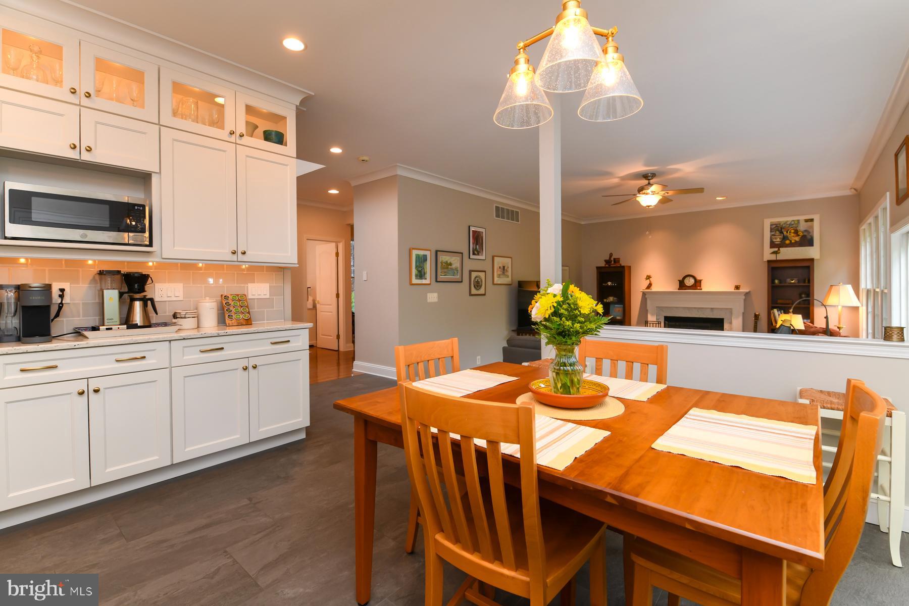 31 Millwood Drive Mickleton, NJ 08056 - Photo 23 of 62 a open kitchen with stainless steel appliances kitchen island granite countertop a table chairs and a refrigerator