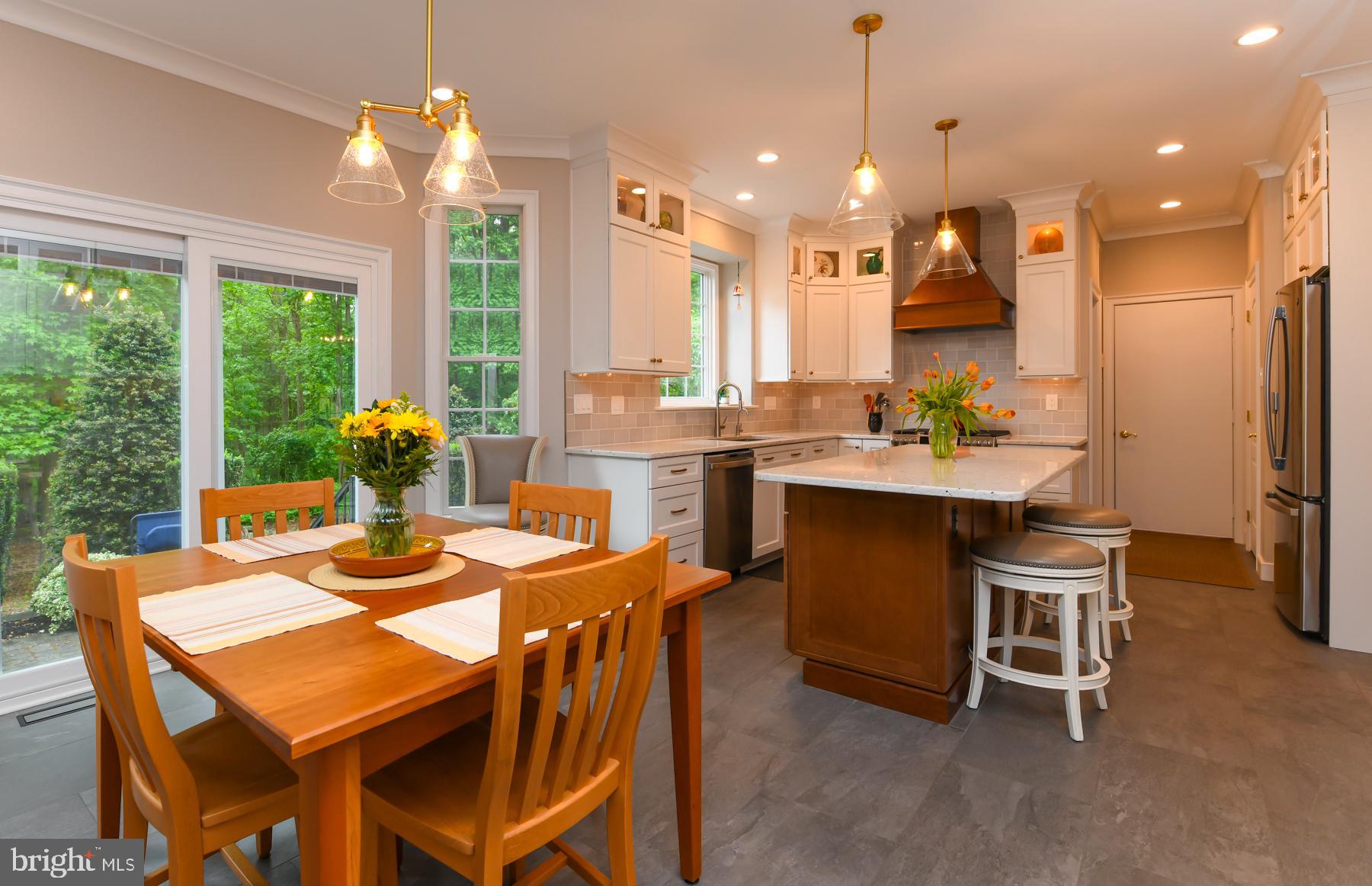 31 Millwood Drive Mickleton, NJ 08056 - Photo 24 of 62 a dining room with a table chairs and a kitchen view