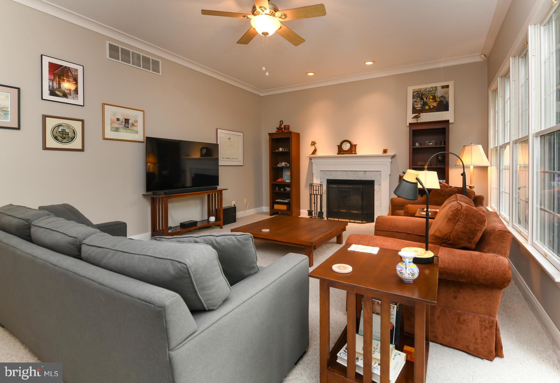 31 Millwood Drive Mickleton, NJ 08056 - Photo 27 of 62 a living room with furniture a flat screen tv and a fireplace