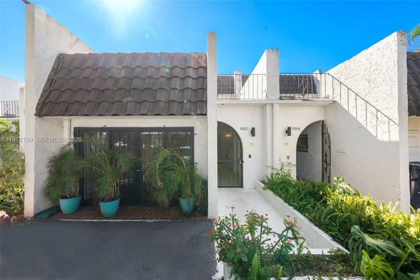 a view of a house with potted plants