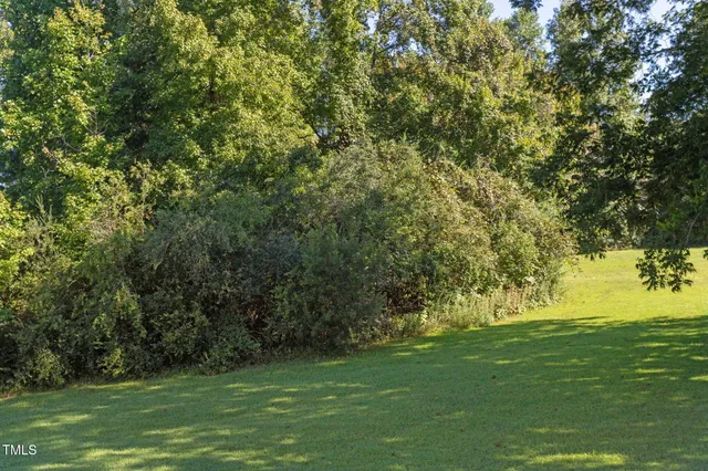 a kitchen that has a lot of cabinets appliances and a dining table