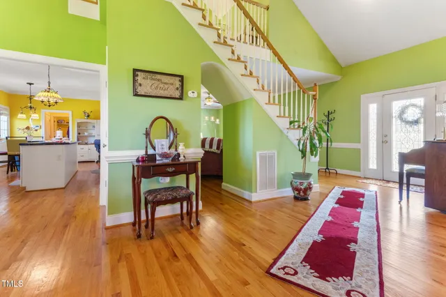 a bathroom with a granite countertop sink toilet and mirror
