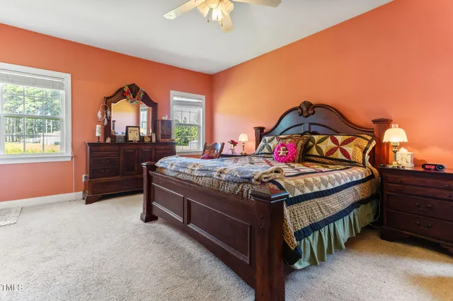 a en suite bathroom with a granite countertop sink and a mirror