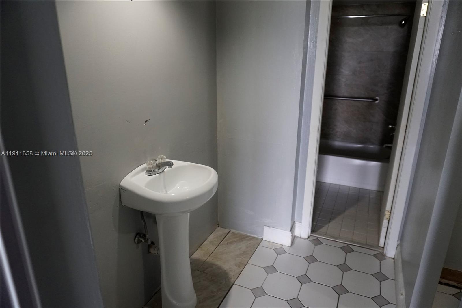 6195 Rock Island Road, Unit 204 Tamarac, FL 33319 - Photo 13 of 23 a bathroom with a sink and mirror