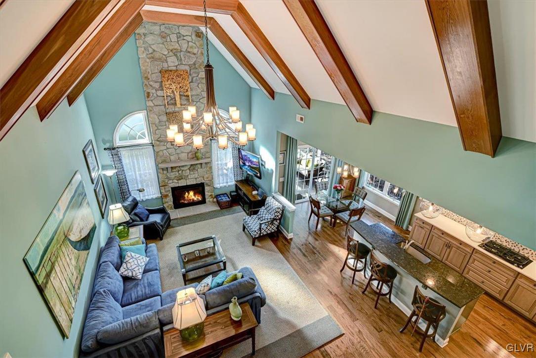1039 Declaration Drive Bethlehem, PA 18017 - Photo 21 of 50 a living room with fireplace furniture and a chandelier