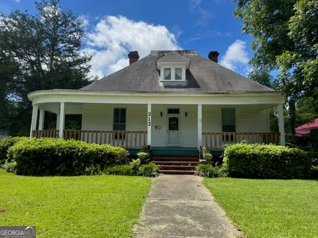 a front view of a house with garden