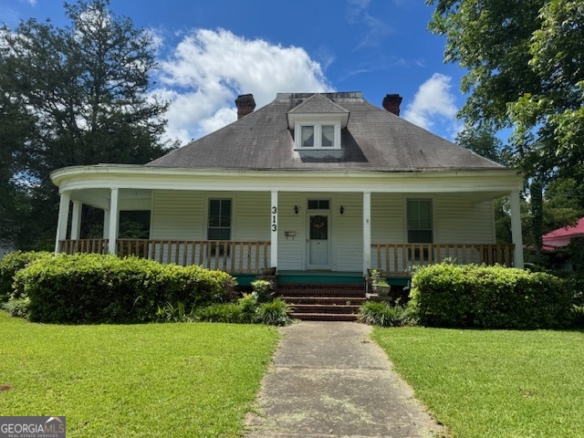 a front view of a house with garden