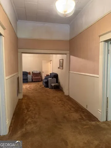 an empty room with windows and cabinet