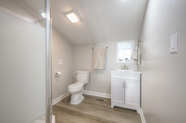 a bathroom with a toilet sink and a mirror