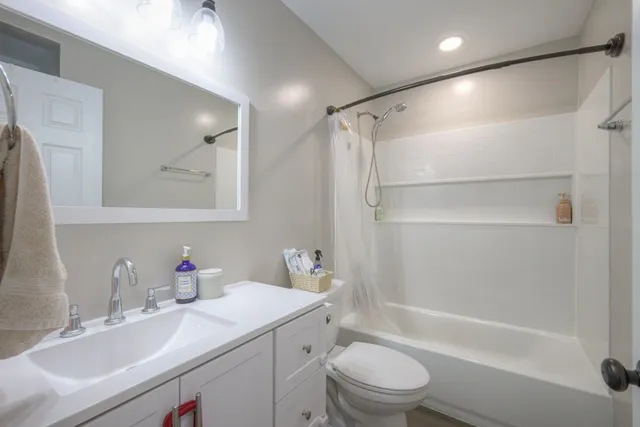 a bathroom with a sink toilet tub and shower