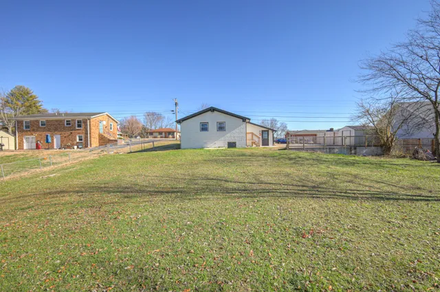a view of a big house with a big yard