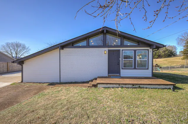 a front view of a house with a yard