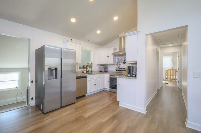 a kitchen with a refrigerator and a stove top oven