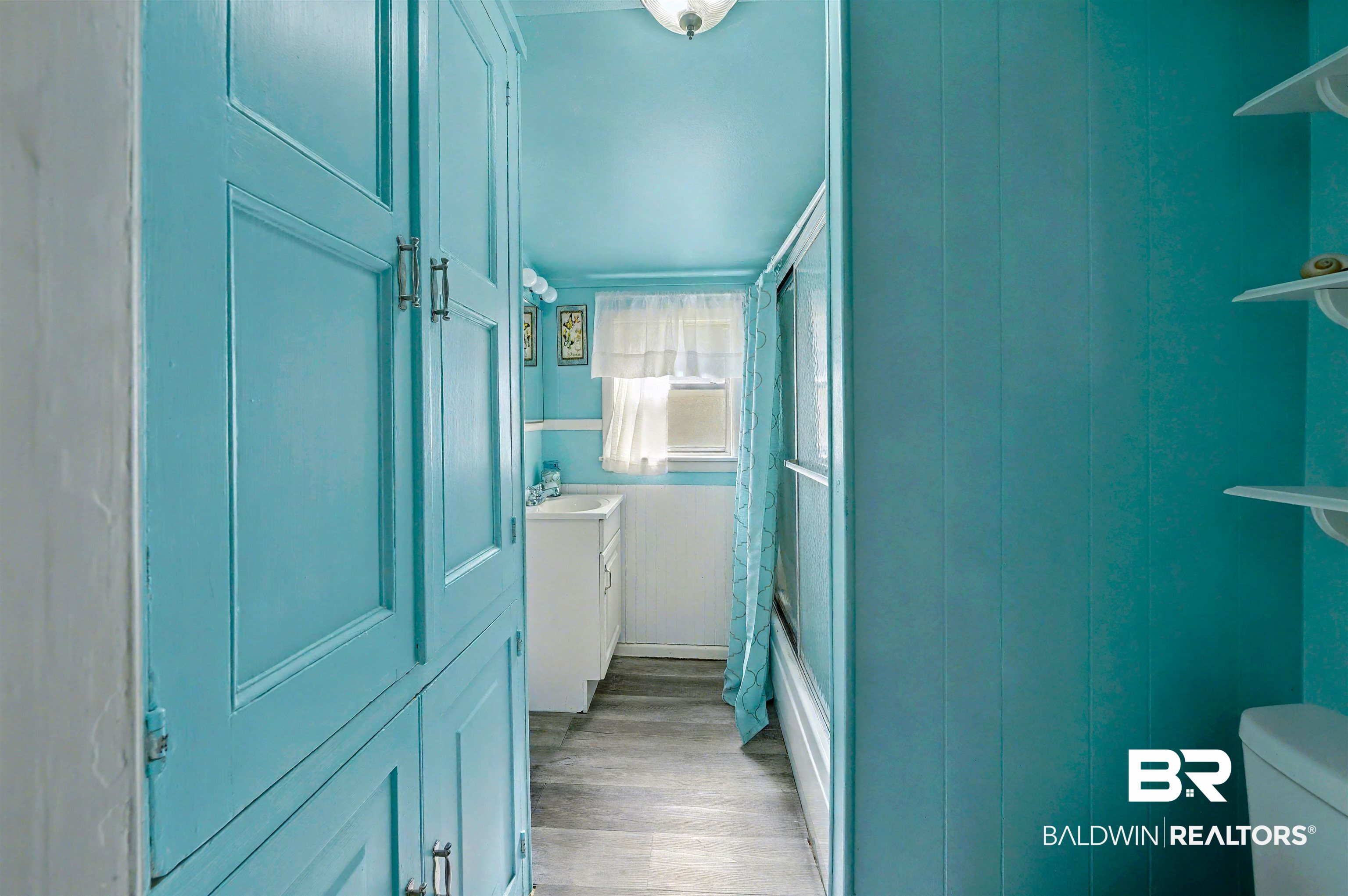 209 West Magnolia Avenue Foley, AL 36535 - Photo 18 of 23 Full bath with vanity, light wood-type flooring, and enclosed tub / shower combo