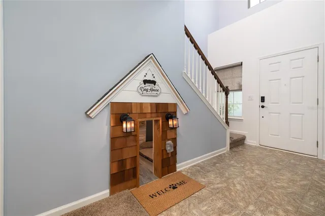 a view of a hallway with wooden floor and entryway