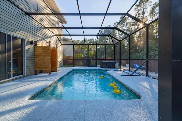 a view of pool with two chairs