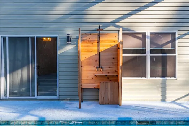a kitchen view with stainless steel appliances kitchen island granite countertop a stove and a large window