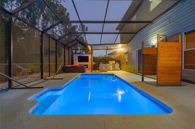 a view of a small house with a small yard and a large tree