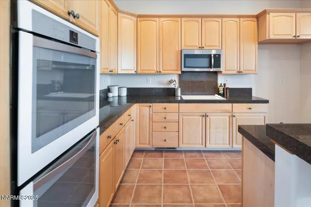 a kitchen with stainless steel appliances a stove and a refrigerator