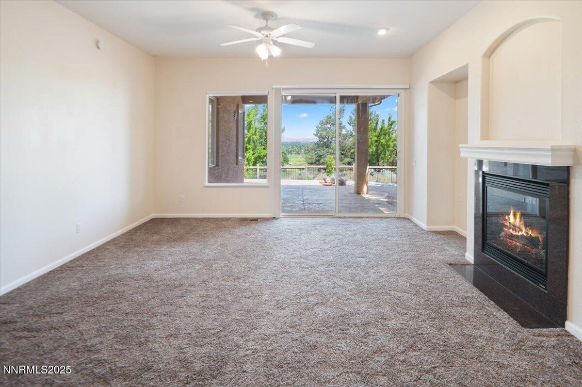 2720 Albazano Drive Sparks, NV 89436 - Photo 19 of 47 a view of livingroom with fireplace large window and front door