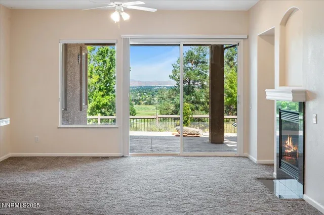 a view of a livingroom with a ceiling fan and window