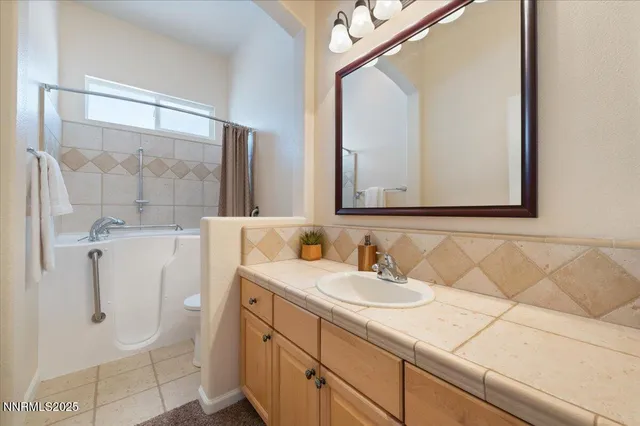 a bathroom with a sink vanity and shower
