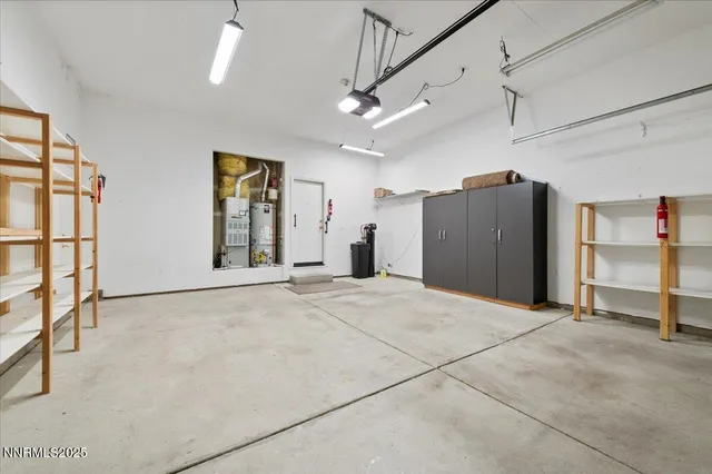 a view of a house with a backyard and floor to ceiling windows